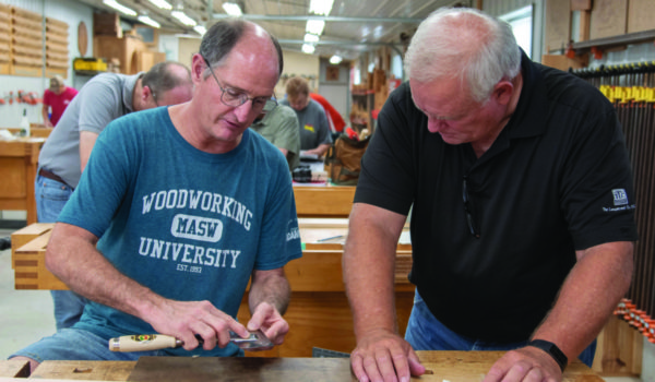Marc Adams helps a student during a basic woodworking workshop in September 2019.
